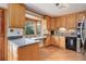 Well-lit kitchen featuring stainless steel appliances, wooden cabinets, and a bay window at 3000 Alkire St, Golden, CO 80401