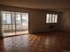 Living room showcasing hardwood floors, natural light, and sliding glass door to a sunroom at 680 S Alton Way # 9A, Denver, CO 80247