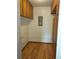 Walk-in pantry with wood cabinets offering ample storage and wood-style flooring at 680 S Alton Way # 9A, Denver, CO 80247