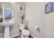 Small powder room with pedestal sink and toilet at 9490 W 14Th Ave # 3, Lakewood, CO 80215