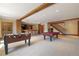Finished basement area with a foosball table, pool table, bar with seating, and stairs at 6455 Dakota Ridge Dr, Golden, CO 80403