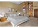 Well-lit bedroom with neutral tones, a fan, and custom windows providing natural light at 6455 Dakota Ridge Dr, Golden, CO 80403