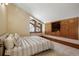Bedroom featuring an attic window, vaulted ceiling and built-in wooden shelving and drawers at 6455 Dakota Ridge Dr, Golden, CO 80403