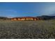 Distant exterior of the illuminated house in the dark with dramatic architecture and large acreage at 6455 Dakota Ridge Dr, Golden, CO 80403