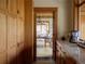 Hallway to a dining room featuring custom cabinets and natural light at 6455 Dakota Ridge Dr, Golden, CO 80403