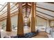 Grand hallway with soaring ceilings, exposed beams, and hardwood floors leading to the living spaces at 6455 Dakota Ridge Dr, Golden, CO 80403