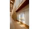 Light-filled hallway with exposed wood beams and trim, wood flooring and custom artwork at 6455 Dakota Ridge Dr, Golden, CO 80403