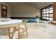 Indoor pool with an adjacent seating area and a table at 6455 Dakota Ridge Dr, Golden, CO 80403