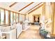 Inviting living room with elegant piano, hardwood floors, grand fireplace, and large windows providing plenty of natural light at 6455 Dakota Ridge Dr, Golden, CO 80403