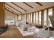 Open-concept living room with vaulted wood ceilings, floor-to-ceiling windows, hardwood floors and piano at 6455 Dakota Ridge Dr, Golden, CO 80403