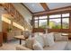 Open concept living area with wood floors, mountain views, and a modern staircase at 6455 Dakota Ridge Dr, Golden, CO 80403