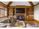Cozy living room featuring a fireplace, custom wood built-ins, and a comfortable sectional sofa at 6455 Dakota Ridge Dr, Golden, CO 80403