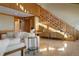 Spacious living room with wood trim, a staircase and tile floors at 6455 Dakota Ridge Dr, Golden, CO 80403