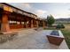 Outdoor patio with stone steps, fire pit, and architectural wood home exterior at 6455 Dakota Ridge Dr, Golden, CO 80403