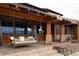 Covered porch with a hanging daybed swing, outdoor heater, and beautiful stone accents at 6455 Dakota Ridge Dr, Golden, CO 80403