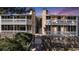 Inviting condo building with charming stone accents and private balconies at sunset at 18106 E Ohio Ave # 103, Aurora, CO 80017