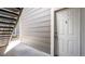 View of the front door of the house with a set of stairs going up the side of the house at 18106 E Ohio Ave # 103, Aurora, CO 80017
