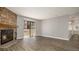 Cozy living room with fireplace, balcony access and wood floors at 18106 E Ohio Ave # 103, Aurora, CO 80017