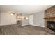 Open-concept living room with wood floors, fireplace and ample space at 18106 E Ohio Ave # 103, Aurora, CO 80017