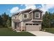 Charming two-story home featuring stone accents, a two-car garage, and well-manicured lawn at 11205 Mount Emma Dr, Englewood, CO 80112