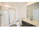 Modern bathroom featuring a glass-enclosed shower, vanity with a large mirror, and sleek finishes at 16582 E 109Th Ave, Commerce City, CO 80022