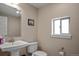 Cozy bathroom with pedestal sink, toilet, and framed art at 2521 Moline St, Aurora, CO 80010