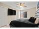 Bedroom featuring a ceiling fan, flat-screen TV, and a large bed at 2521 Moline St, Aurora, CO 80010