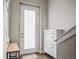 Bright entryway with a frosted glass door, hardwood floors, storage cabinet and bench at 2521 Moline St, Aurora, CO 80010