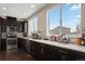 Modern kitchen with stainless steel appliances, dark cabinets, and light countertops at 2521 Moline St, Aurora, CO 80010