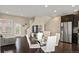 Spacious living room with adjacent kitchen, hardwood floors, and stairs at 2521 Moline St, Aurora, CO 80010