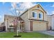 Inviting two-story home features a well-manicured lawn, a two-car garage, and a classic design at 4774 Coker Ave, Castle Rock, CO 80104