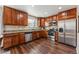 Well-equipped kitchen with stainless steel appliances, granite countertops, and warm wood cabinets at 4774 Coker Ave, Castle Rock, CO 80104