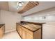 Finished basement wet bar with custom wood counters, shaker-style cabinets and open to the rec room at 1010 Ash St, Broomfield, CO 80020