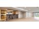 Spacious finished basement rec room with bar, wood-look flooring and slider doors to the backyard at 1010 Ash St, Broomfield, CO 80020