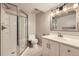 Bathroom featuring a glass shower, a toilet and a white vanity with framed mirror at 1010 Ash St, Broomfield, CO 80020