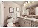 Well-lit bathroom features a vanity with marble countertops and tiled floors at 1010 Ash St, Broomfield, CO 80020