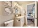 Comfortable bathroom features a modern vanity, decorative artwork, and tiled floors at 1010 Ash St, Broomfield, CO 80020