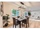 The dining room has a natural light fixture and a large window with manicured plants at 1010 Ash St, Broomfield, CO 80020