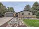 Charming home featuring unique brickwork, a well-manicured yard, and a two-car garage at 1010 Ash St, Broomfield, CO 80020