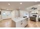 Bright, airy kitchen features an island with quartz countertop and stainless steel appliances in an open-concept living space at 1010 Ash St, Broomfield, CO 80020