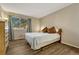 Bright bedroom with wood-look floors and neutral decor at 4313 S Andes Way # 103, Aurora, CO 80015