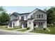 Attractive townhome featuring a blend of stone and siding, complemented by well-maintained landscaping at 6579 Parterre N Pkwy # 1, Thornton, CO 80602