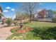 Beautiful backyard with a stone patio, tiered fountain, and vibrant garden beds at 6502 Shea Pl, Highlands Ranch, CO 80130