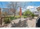 Backyard features a large deck with patio furniture, a manicured lawn, a privacy fence, and mature trees at 6502 Shea Pl, Highlands Ranch, CO 80130