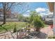 Backyard featuring a patio, mature trees, and a well-manicured lawn create a peaceful outdoor space at 6502 Shea Pl, Highlands Ranch, CO 80130