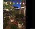 Outdoor patio with lush foliage, string lights, and comfortable seating provides a relaxing and inviting atmosphere at 6502 Shea Pl, Highlands Ranch, CO 80130
