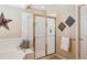 Bathroom showcasing a glass shower, soaking tub, and decorative tile accents at 6502 Shea Pl, Highlands Ranch, CO 80130