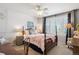 Charming bedroom featuring a four-poster bed, neutral carpet, and bright window at 6502 Shea Pl, Highlands Ranch, CO 80130