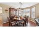 Formal dining room with hardwood floors, stylish lighting, and seating for six at 6502 Shea Pl, Highlands Ranch, CO 80130