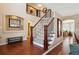 Elegant entryway with hardwood floors, staircase, and stylish decor at 6502 Shea Pl, Highlands Ranch, CO 80130